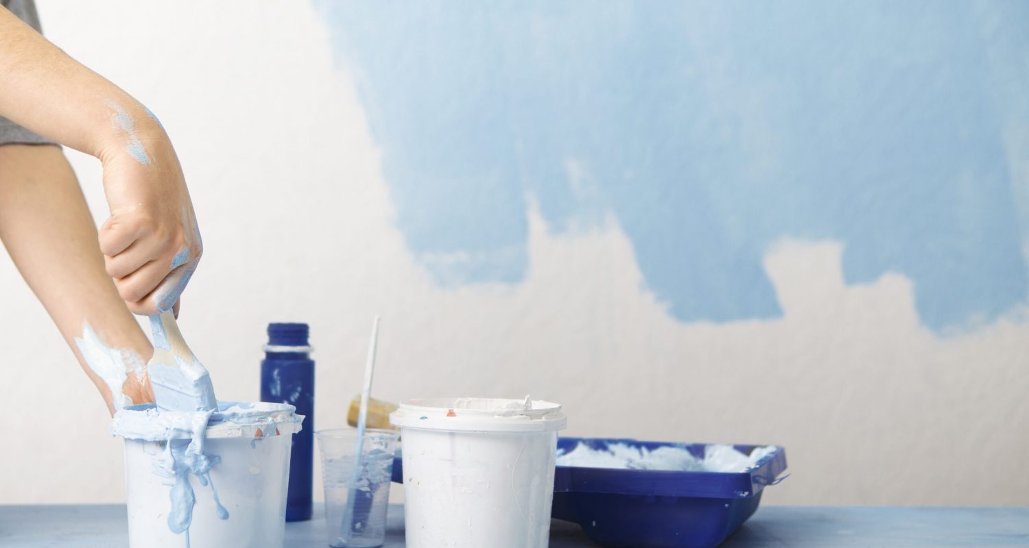 Homemade repair. Girls hand mixes blue paint, free space